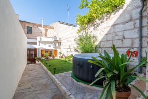 a garden with a large blue barrel next to a building at Son Amanada in Santa Margalida