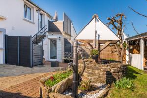 a home with a stone retaining wall and a house at Kervalou in Sainte Anne d'Auray