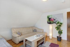 a living room with a couch and a coffee table at Ferienwohnung Honacker in Steißlingen