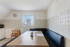 a dining room with a table and a window at Ferienwohnung Honacker in Steißlingen +14 photos