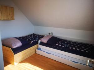 a bedroom with two twin beds in a room at Ferienwohnung Eckert in Wehr +12 photos
