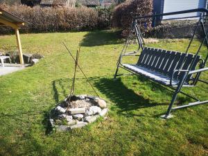 a bench in a yard with a rock garden at Ferienwohnung Eckert in Wehr