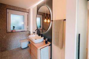a bathroom with a sink and a mirror at Fewo Tauberblick in Röttingen