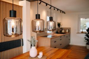 a kitchen with a table with several lights at Fewo Tauberblick in Röttingen +17 photos