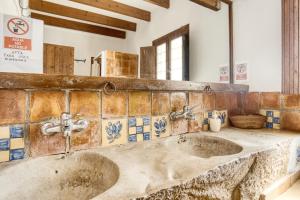 a bathroom with two sinks and a mirror at Madara in Monóvar +25 photos