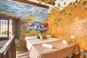 a bedroom with a painting on the wall at Madara in Monóvar