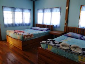 Voodi või voodid majutusasutuse Koh Mak Green View Resort toas