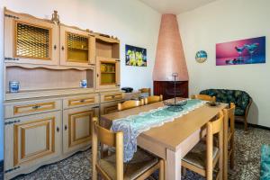 a kitchen with a wooden table and a dining room at Casa Margherita in Nebida