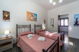 a bedroom with two beds with towels on them at Casa Margherita in Nebida