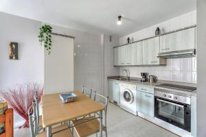 a kitchen with a table and a dining room at Apartamento Retama in Adeje