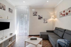 a living room with a couch and a tv at Casa Acqua Mare Parasio in Imperia