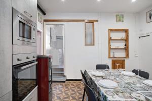 a kitchen with a table with plates on it at Casa Acqua Mare Parasio in Imperia