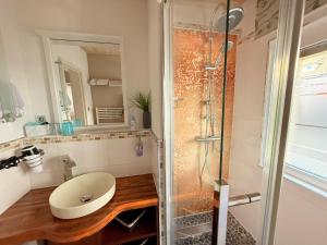 a bathroom with a sink and a shower at Ferienwohnung Bullentäle in Albstadt +3 photos