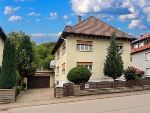 a house with a fence in front of it at Ferienwohnung Bullentäle in Albstadt