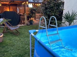 a blue pool with a ladder next to a chair at Ferienwohnung Bullentäle in Albstadt