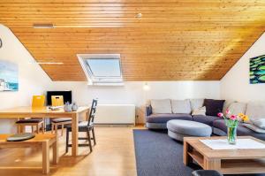 a living room with a couch and a table at Vronis Ferienwohnungen in Mühlingen