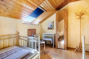 a bedroom with a bed and a table in a room at Vronis Ferienwohnungen in Mühlingen