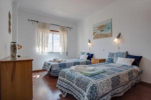 a hotel room with two beds and a couch at Your Secret in Lagos in Lagos +15 photos