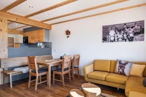 a living room with a table and a couch at Gantershof in Titisee-Neustadt