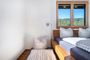 a room with two beds and a window at Gantershof in Titisee-Neustadt