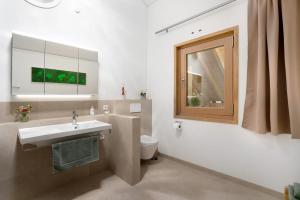 a bathroom with a sink and a toilet at Ferienwohnung Marie in Egling +26 photos
