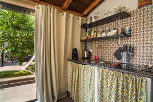 a kitchen with a counter in a room at A Ugghia in Fiumefreddo di Sicilia