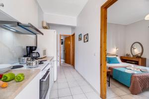 a kitchen and a bedroom with a bed in a room at Nikoleta Apartment A in Nikiana +17 photos