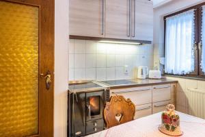 a kitchen with a table and a stove top oven at Am Wehrastrand App Eg in Todtmoos +24 photos