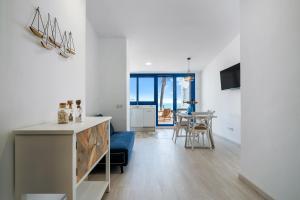 a kitchen and living room with a table and chairs at Calafellmar loft in Calafell