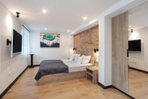 a bedroom with a bed and a brick wall at Heimelige Schwarzwaldwohnung Stein in Häusern