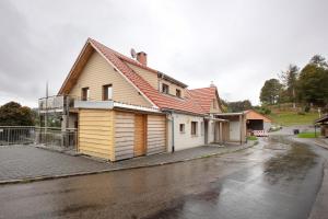 a house sitting on the side of a street at Heimelige Schwarzwaldwohnung Stein in Häusern