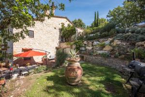 a garden with a large pot with a plant in it at Podere Erbolino in Gaiole in Chianti