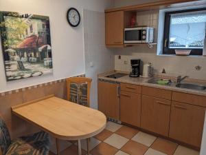 a small kitchen with a table and a sink at Appartement Karolina in Bad Soden-Salmünster