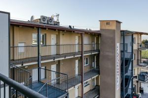 an apartment building with balconies and a clock on top at Giuliano Empuria para 6 personas in Empuriabrava