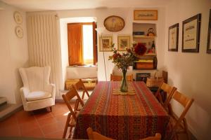 a dining room with a table with a vase of flowers on it at Casa Annamaria in Arcola