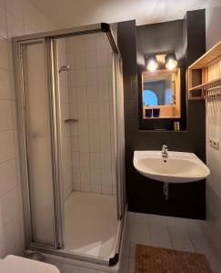 a bathroom with a shower and a sink at Ferienwohnung im Burghotel in Aschau im Chiemgau