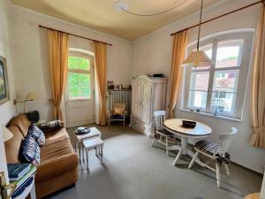 a living room with a couch and a table at Ferienwohnung im Burghotel in Aschau im Chiemgau