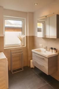 a bathroom with a sink and a window at Ferienwohnung Pruggernglück in Pruggern +25 photos
