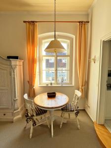 a dining room with a table and chairs and a window at Ferienwohnung im Burghotel in Aschau im Chiemgau +18 photos