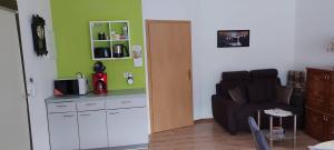 a living room with a couch and a table at Ferienwohnung in Spreewaldnähe in Kolkwitz