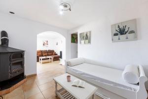 a living room with a white couch and a fireplace at Vista al Mar Ylenia in Almería