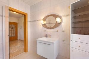 a white bathroom with a sink and a mirror at Ferienwohnung mit Charme in Peitz +24 photos