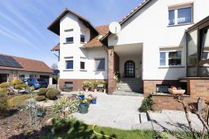 a large white house with a driveway at Ferienwohnung mit Charme in Peitz