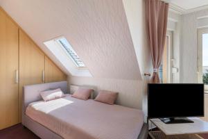 a bedroom with a bed and a flat screen tv at Ferienwohnung mit Charme in Peitz