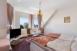a bedroom with a bed and a flat screen tv at Ferienwohnung mit Charme in Peitz