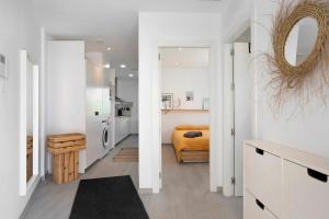a white room with a bed and a kitchen at Casa Maracuya in Tarifa +12 photos