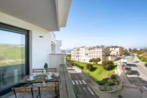 a balcony with a table and a view of a street at Casa Maracuya in Tarifa