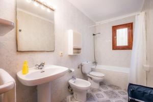 a white bathroom with a sink and a toilet at Ca Ses Mestres in Santanyi +26 photos