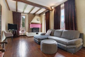 a living room with a couch and a tv at Villa Oleandra - Como Lake in Dizzasco