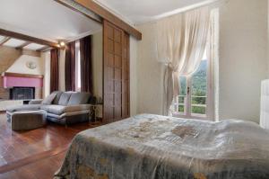a bedroom with a bed and a living room with a couch at Villa Oleandra - Como Lake in Dizzasco +35 photos